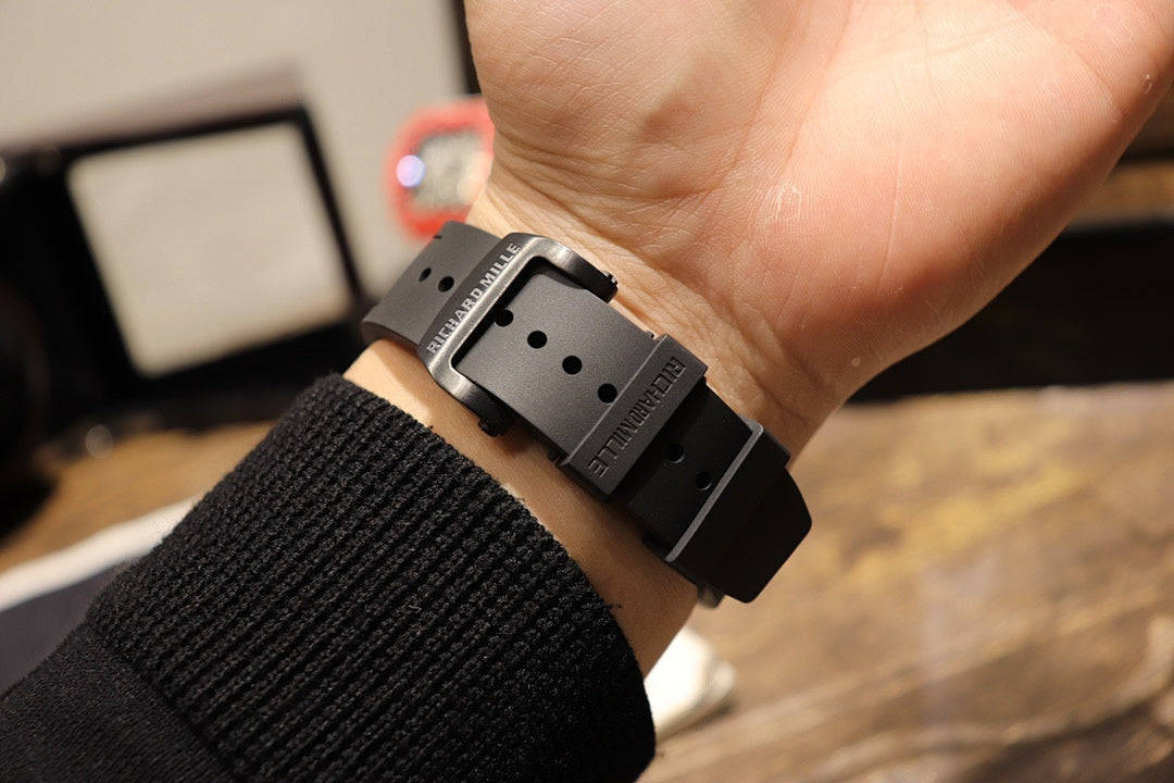 Black rubber strap watch clasp view, square case back