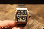 Rose gold-tone wristwatch showing time on dial with black rubber strap