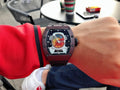 Richard Mille watch with burgundy case and black rubber strap, skeleton-style dial