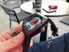 Richard Mille watch angled view, burgundy case and black strap with openwork dial