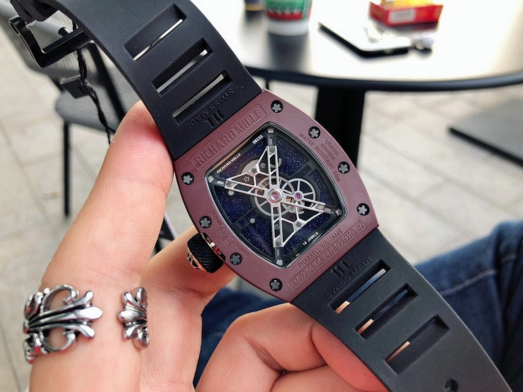 Richard Mille watch side view, burgundy case with dark openwork dial, rubber strap