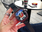 Richard Mille timepiece on dark rubber strap, burgundy case with blue-toned skeleton dial