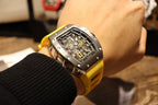Richard Mille wristwatch with yellow strap and black skeleton face, viewed at an angle.