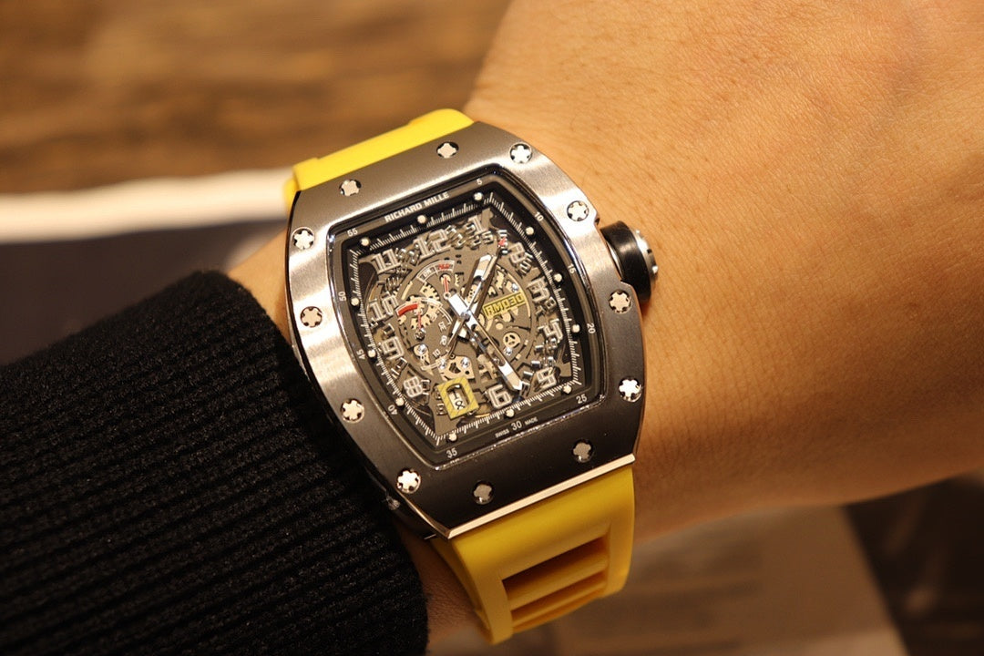 Richard Mille wristwatch with yellow rubber strap, black dial with visible skeleton movement