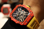 Red skeleton tourbillon watch close-up with black dial and yellow rubber strap