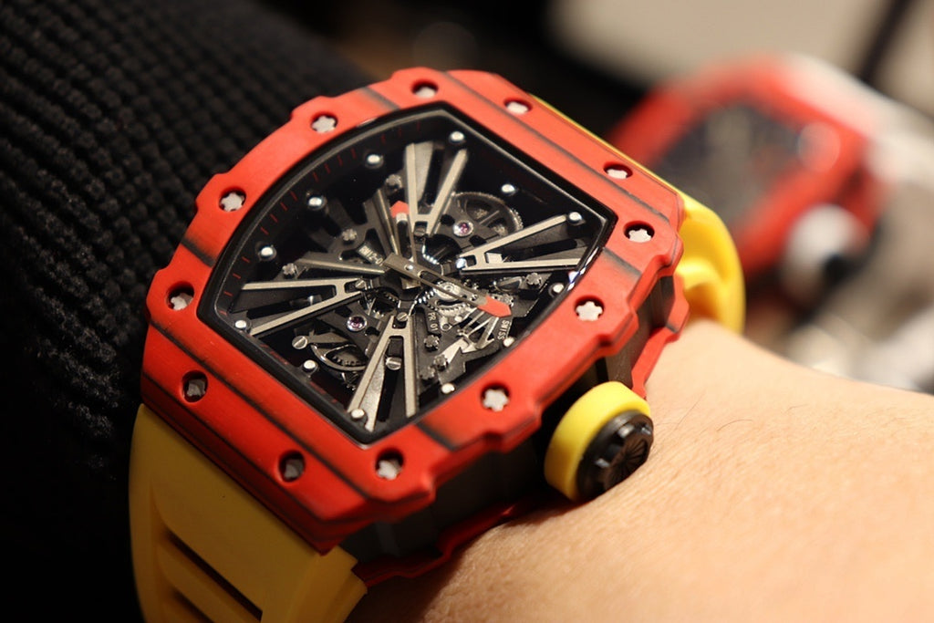 Red skeleton tourbillon watch with crown, black dial, yellow rubber strap