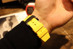 Yellow rubber watch strap and buckle on wrist