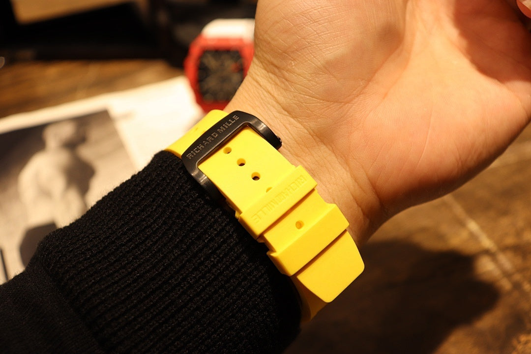Yellow rubber watch strap and buckle on wrist