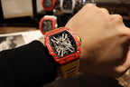 Red skeleton tourbillon watch with black dial on wrist, yellow rubber strap