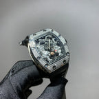 Silver-toned wristwatch with jeweled bezel, skeleton dial, and black strap