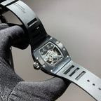 Black-toned wristwatch case and strap with openwork skeleton dial detail