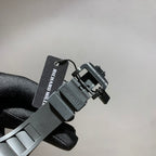 Wristwatch strap with black metal clasp and hanging Richard Mille tag