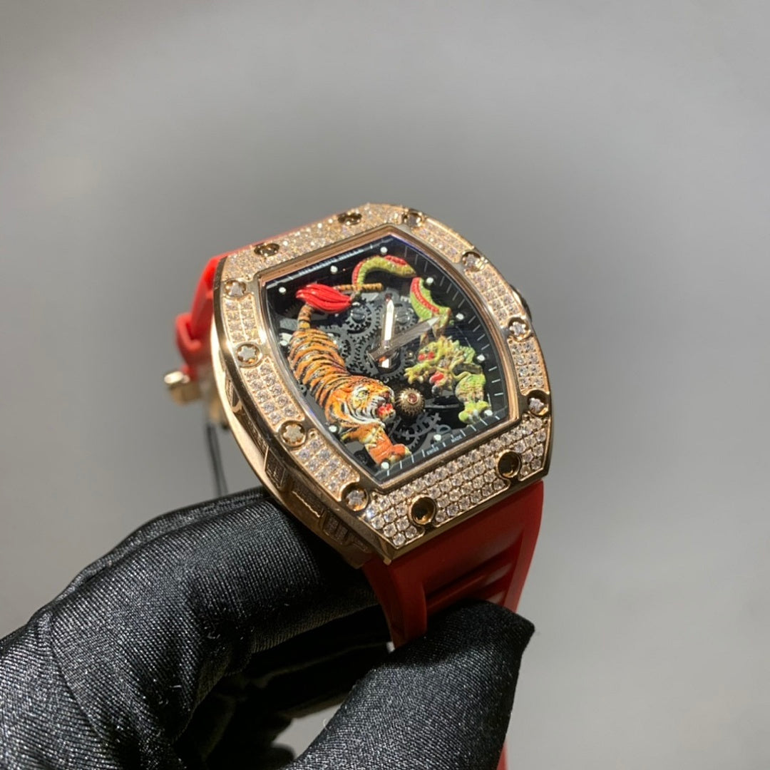 Gold-toned wristwatch with jeweled bezel, colorful skeleton dial, and red strap