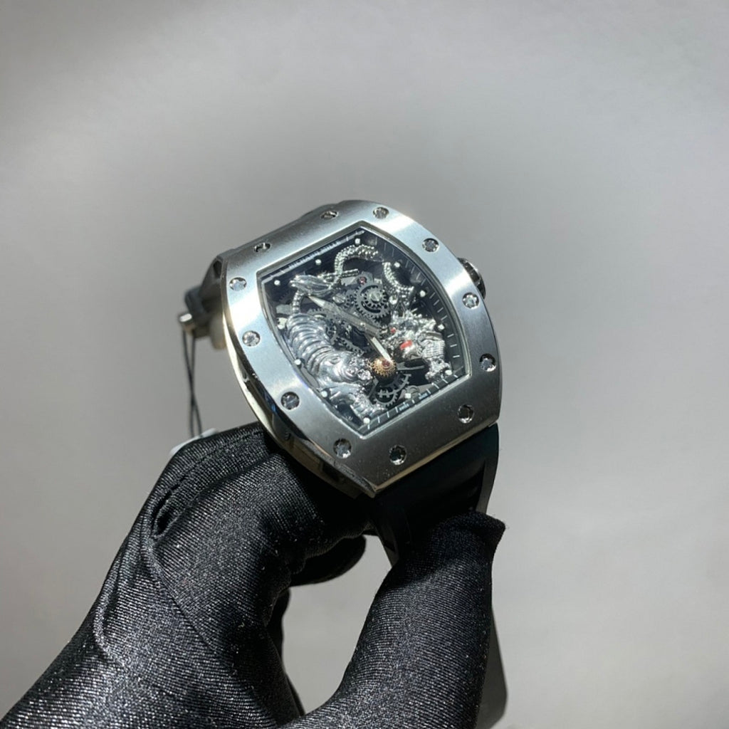 Richard Mille watch with dark case, black strap, and monochrome skeleton dial with visible gears