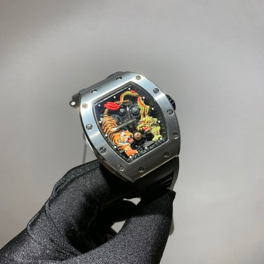 Richard Mille watch with silver-toned case, black strap, and colorful skeleton dial with dragon motif