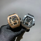 Two Richard Mille watches held in black-gloved hand, each with exposed skeleton dial