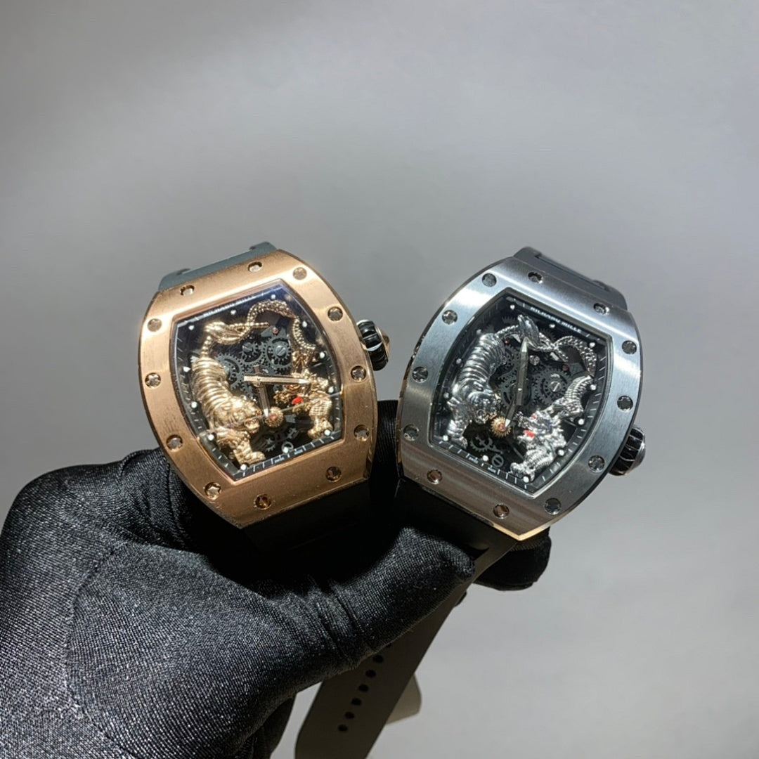Two Richard Mille watches held in black-gloved hand, each with exposed skeleton dial