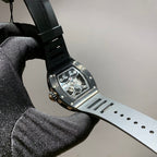 Richard Mille watch with dark dial, light gray strap, and skeleton movement visible
