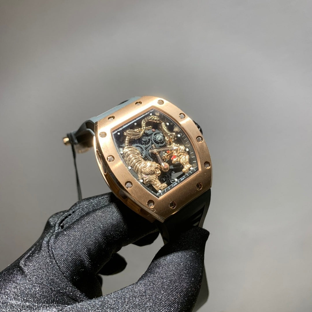 Richard Mille watch with gold-toned case, black strap, and skeleton dial with rotating gears