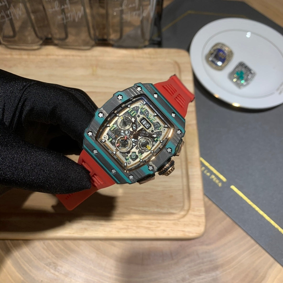 Richard Mille watch close-up with teal frame and red strap, exposed skeleton dial.