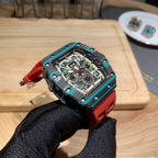 Richard Mille watch tilted view: teal bezel, red strap, detailed skeleton movement.