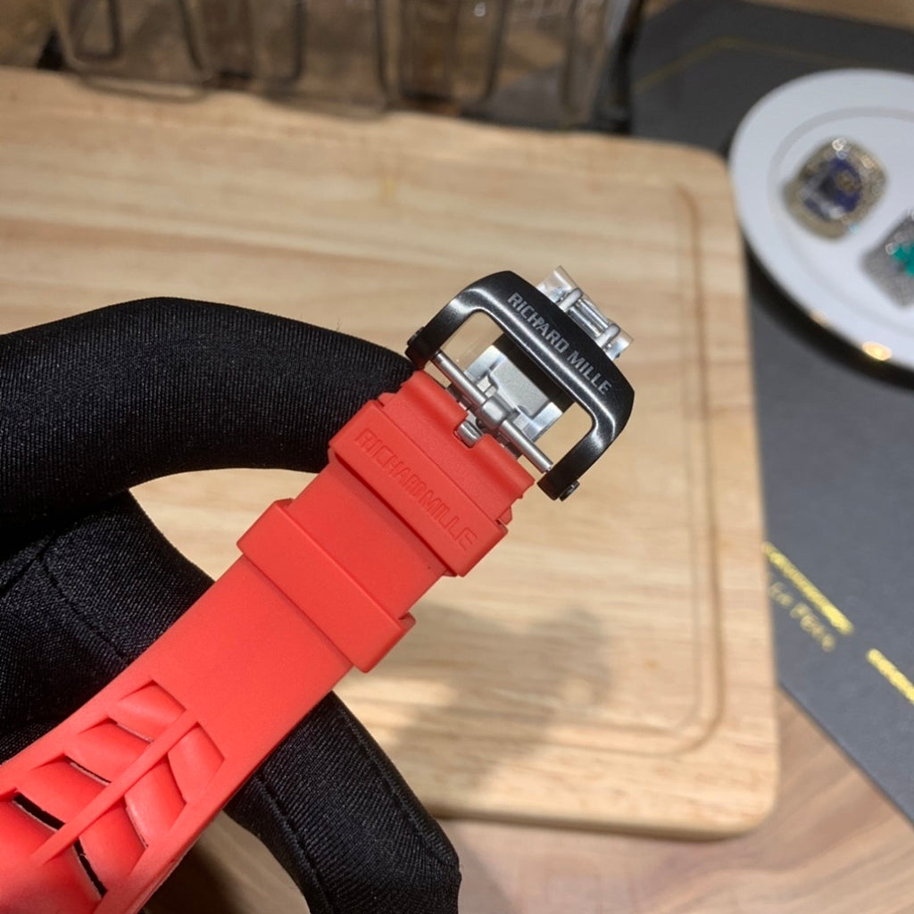Richard Mille watch band buckle in metal on red rubber strap.