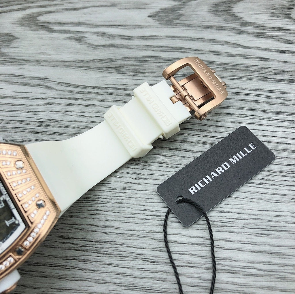 Rose-gold buckle clasp on white rubber watch strap