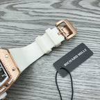 Rose-gold buckle clasp on white rubber watch strap