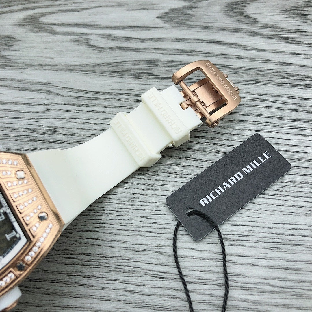 Rose-gold buckle clasp on white rubber watch strap