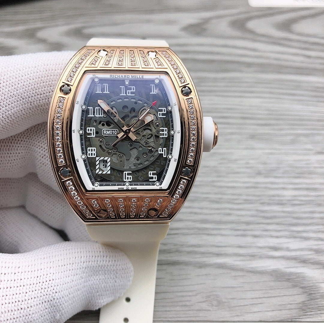 Rose-gold tonneau watch with diamond bezel and white rubber strap