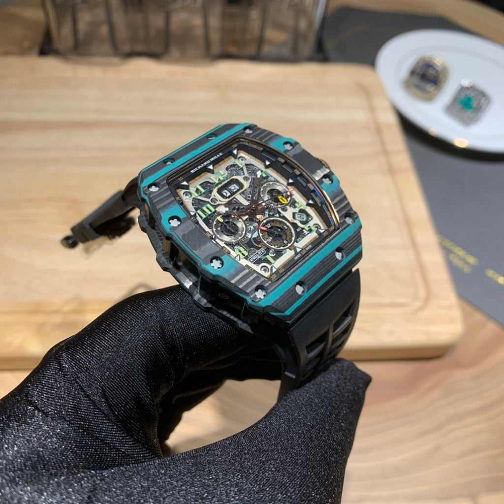 Richard Mille wristwatch angled view with teal bezel and black rubber strap