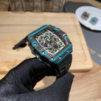 Richard Mille wristwatch angled view with teal bezel and black rubber strap