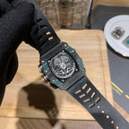 Richard Mille wristwatch case side with black rubber strap and teal bezel details
