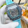 Richard Mille wristwatch with black camo case, blue strap, and transparent skeleton dial.