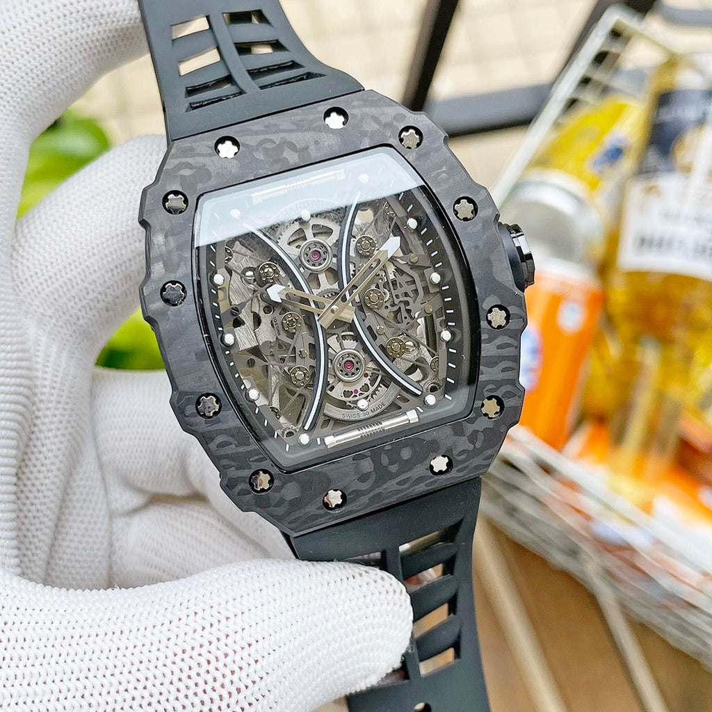 Richard Mille wristwatch with dark camo case and transparent skeleton dial, gray strap.