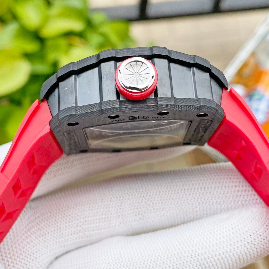 Richard Mille watch caseback with black frame and red circular detail, on wrist.