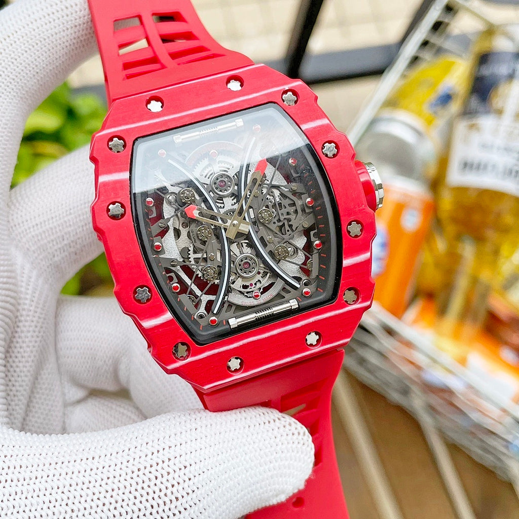 Richard Mille wristwatch with red case accents and see-through skeleton dial, red strap.