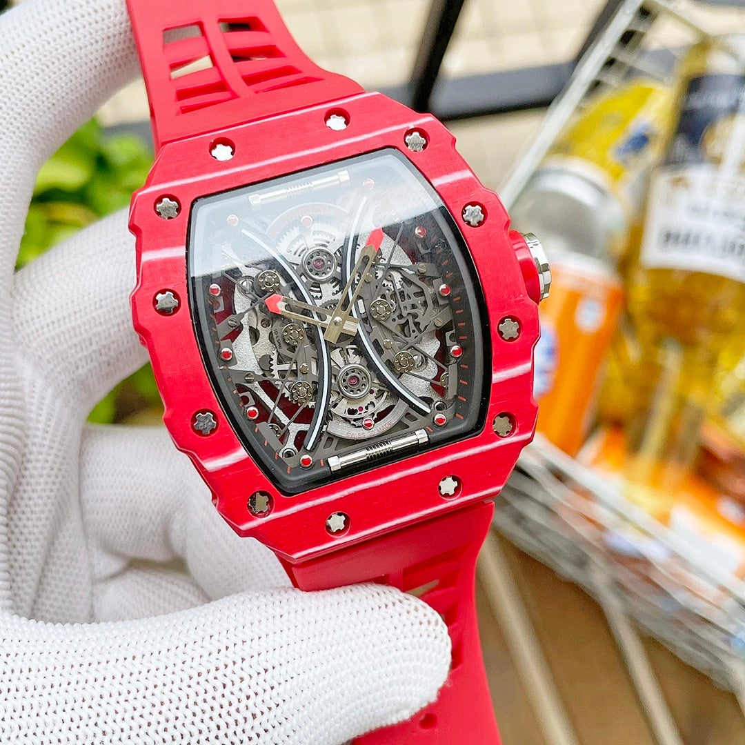 Richard Mille wristwatch with red case accents and see-through skeleton dial, red strap.