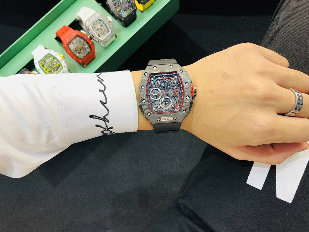 Richard Mille watch on wrist with black rubber strap and silver-toned skeleton case