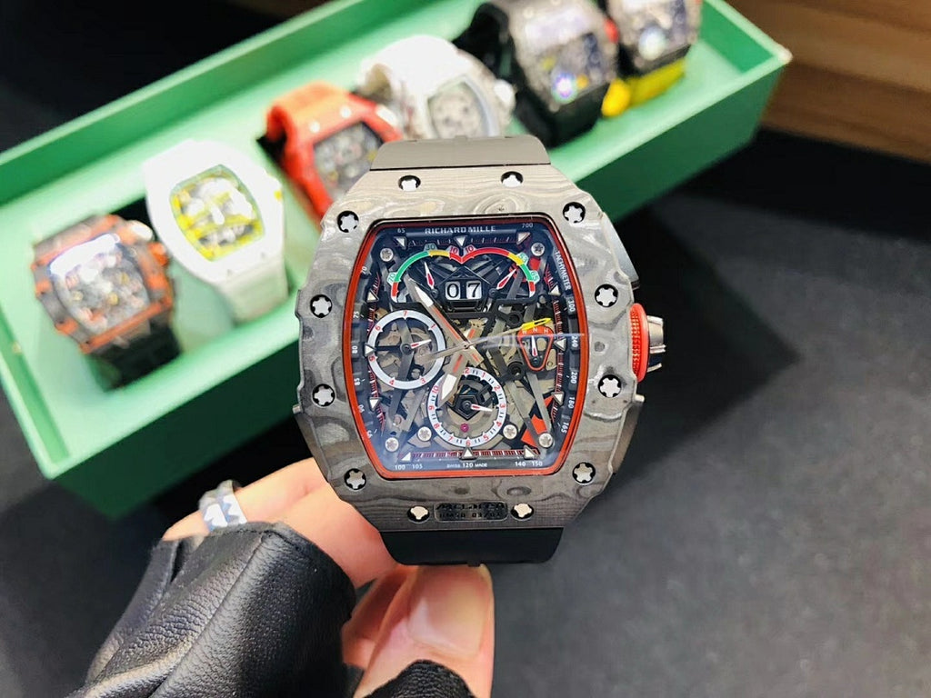 Richard Mille watch front view with silver-toned case, skeleton dial, and black rubber strap