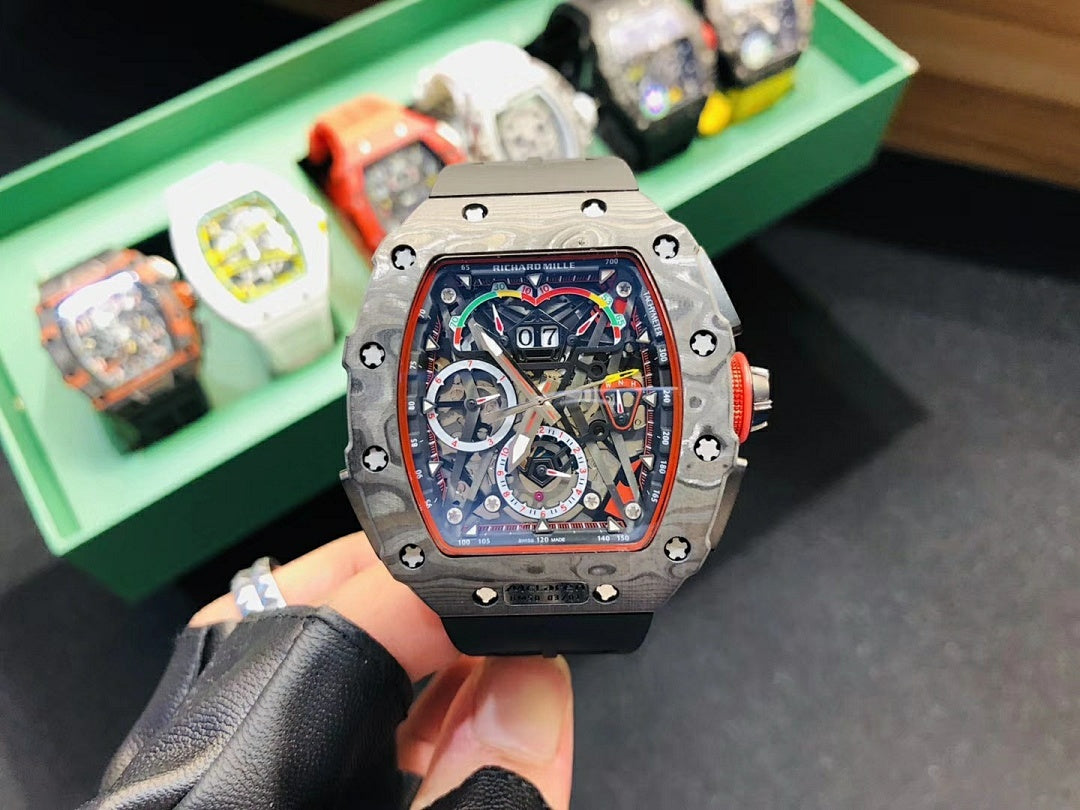 Richard Mille watch front view with silver-toned case, skeleton dial, and black rubber strap