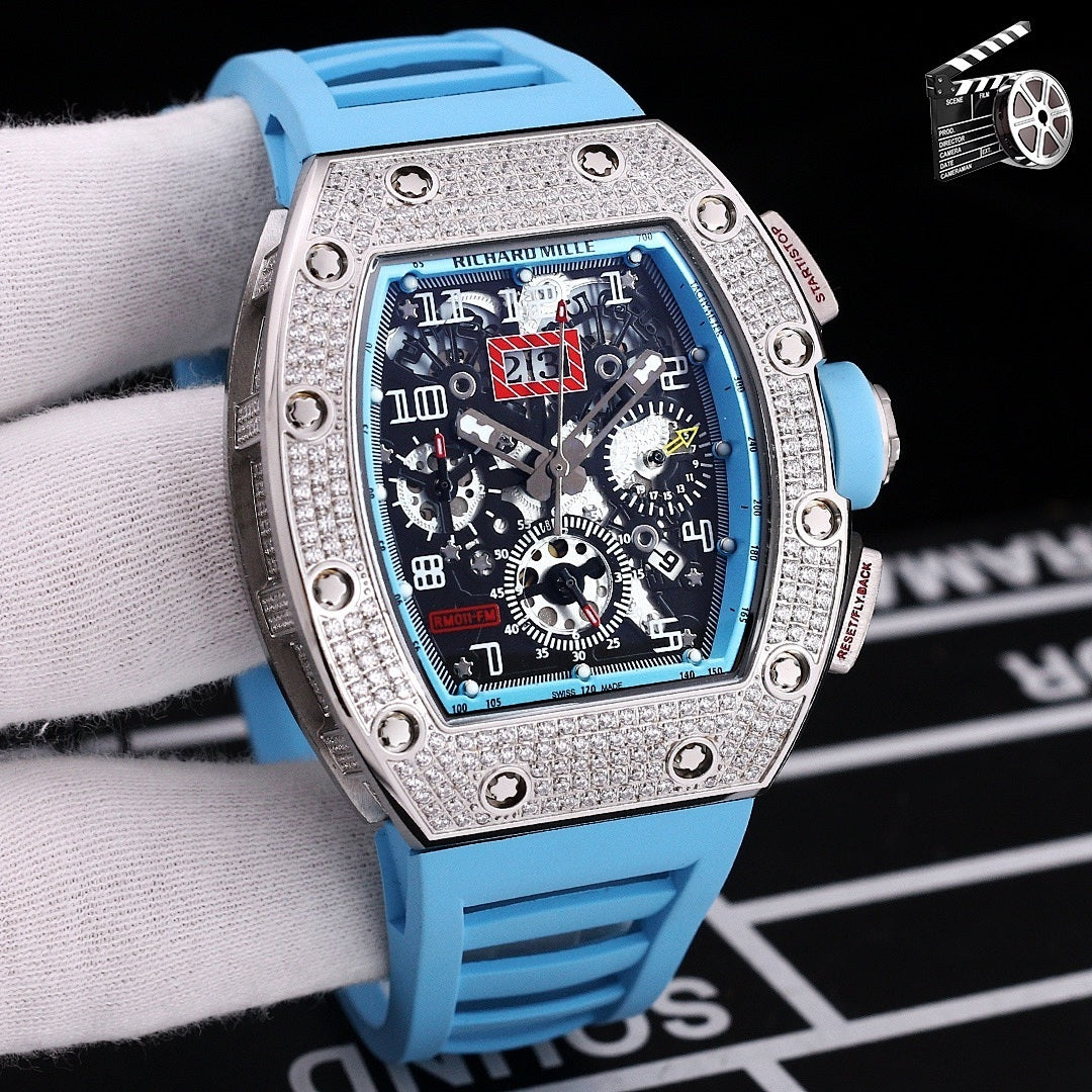 Wristwatch with silver case, blue silicone strap, skeleton dial with visible gears