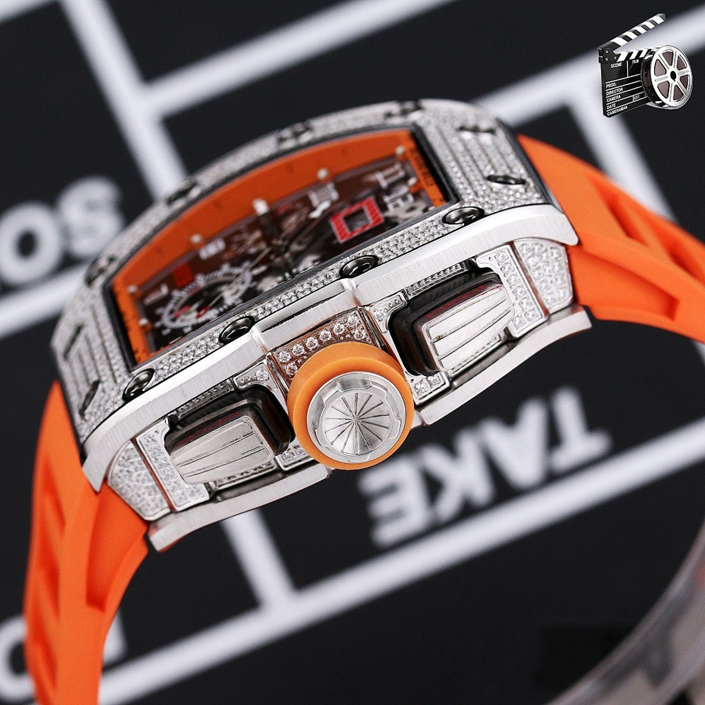 Luxury wristwatch side view with orange silicone strap and faceted silver bezel