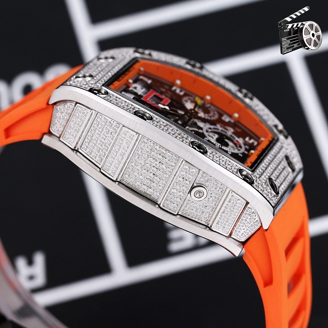Wristwatch side close-up with orange silicone strap and textured silver case band