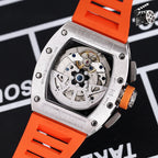Wristwatch back view with orange silicone strap, exposed movement inside silver case