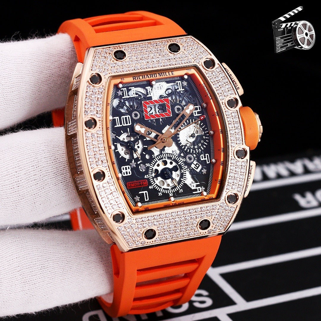 Rose gold diamond bezel wristwatch with orange silicone strap and skeleton dial.