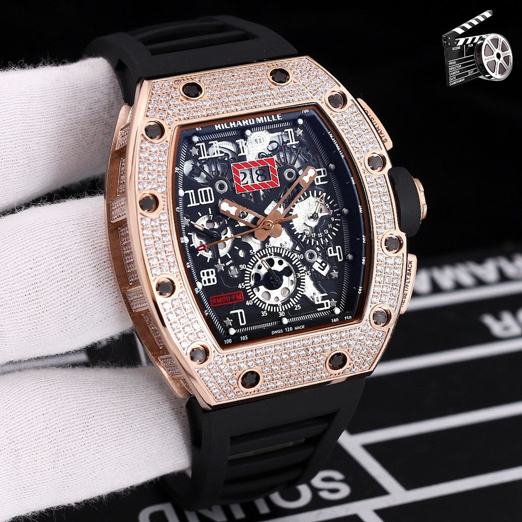 Rose gold diamond bezel wristwatch with black silicone strap and skeleton dial.