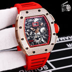 Rose gold diamond bezel wristwatch with red silicone strap and skeleton dial.