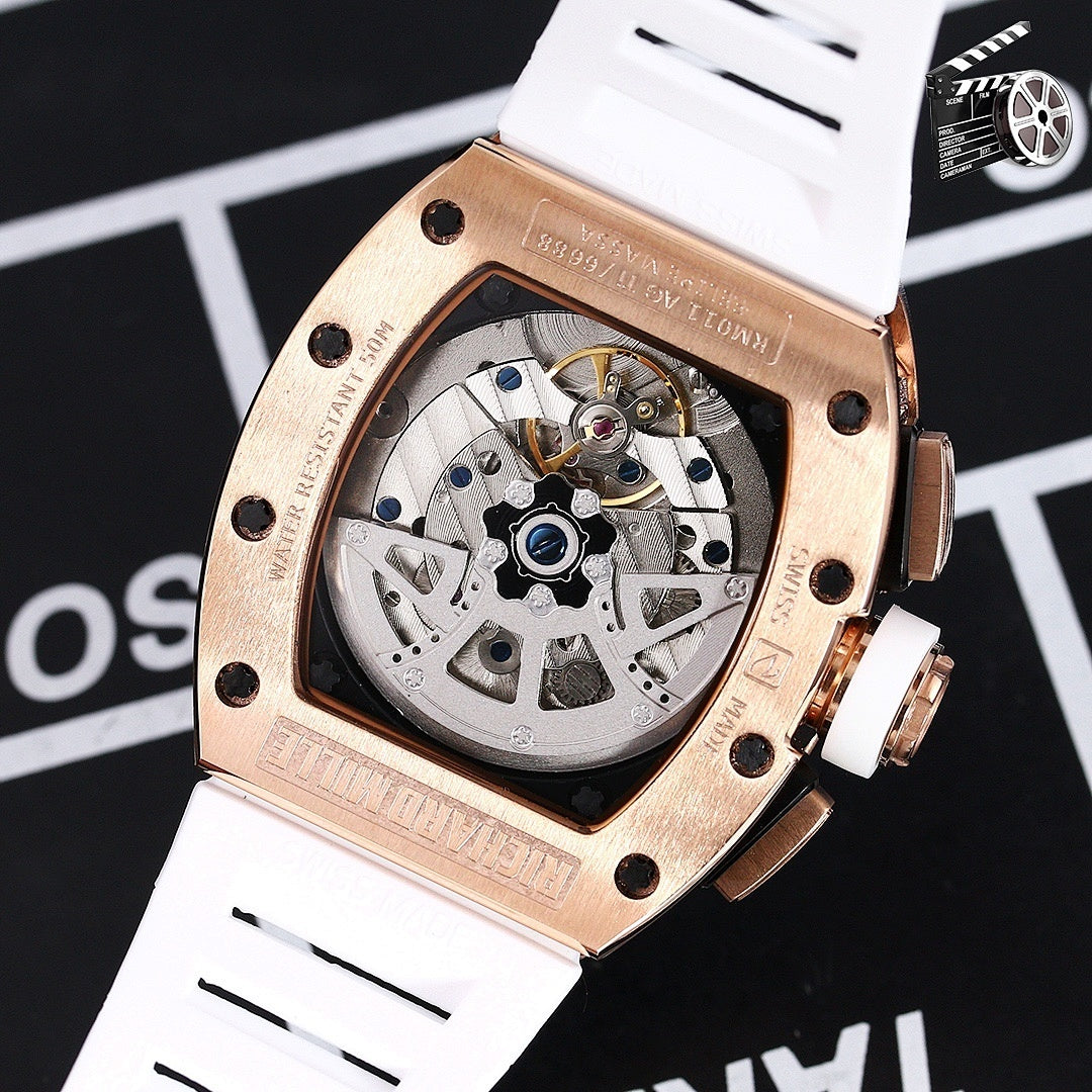 Rose gold watch back with visible movement and white silicone strap.