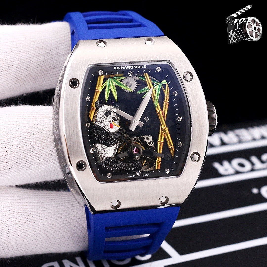 Richard Mille watch with blue rubber strap, stainless case, skeleton dial with green accents.